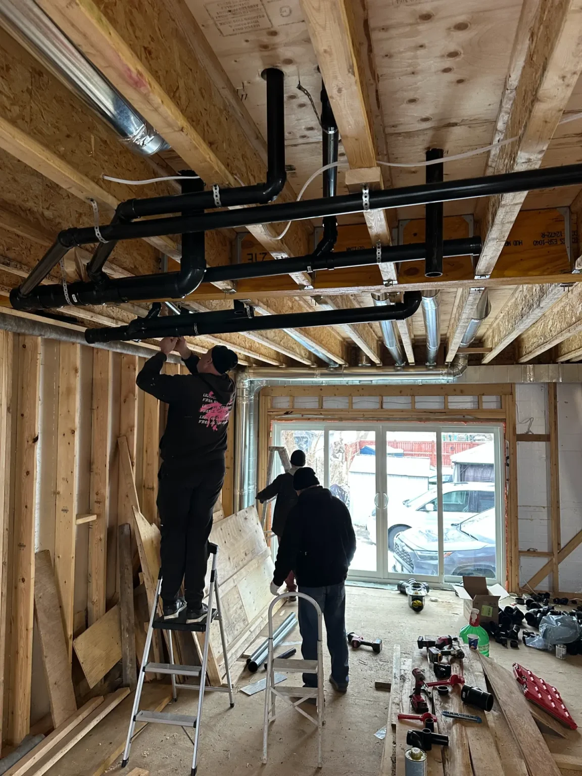 Main drain lines running through a basement, cleared by Plumbify